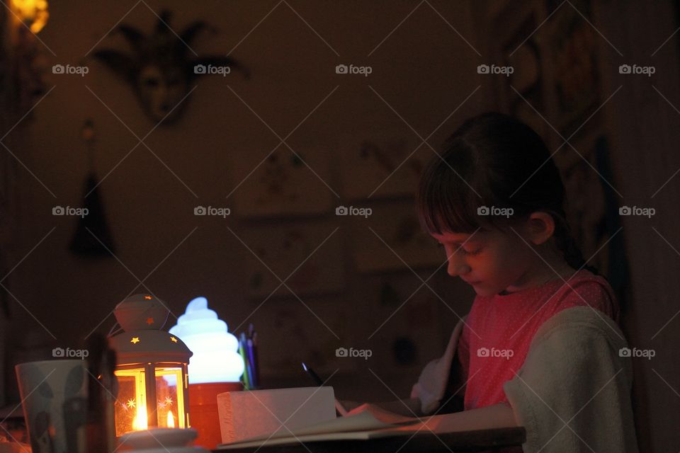 Little girl prepares for the holiday and writes a letter to Santa Claus