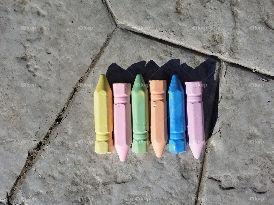 Let's go outside and play with colorful chalk.