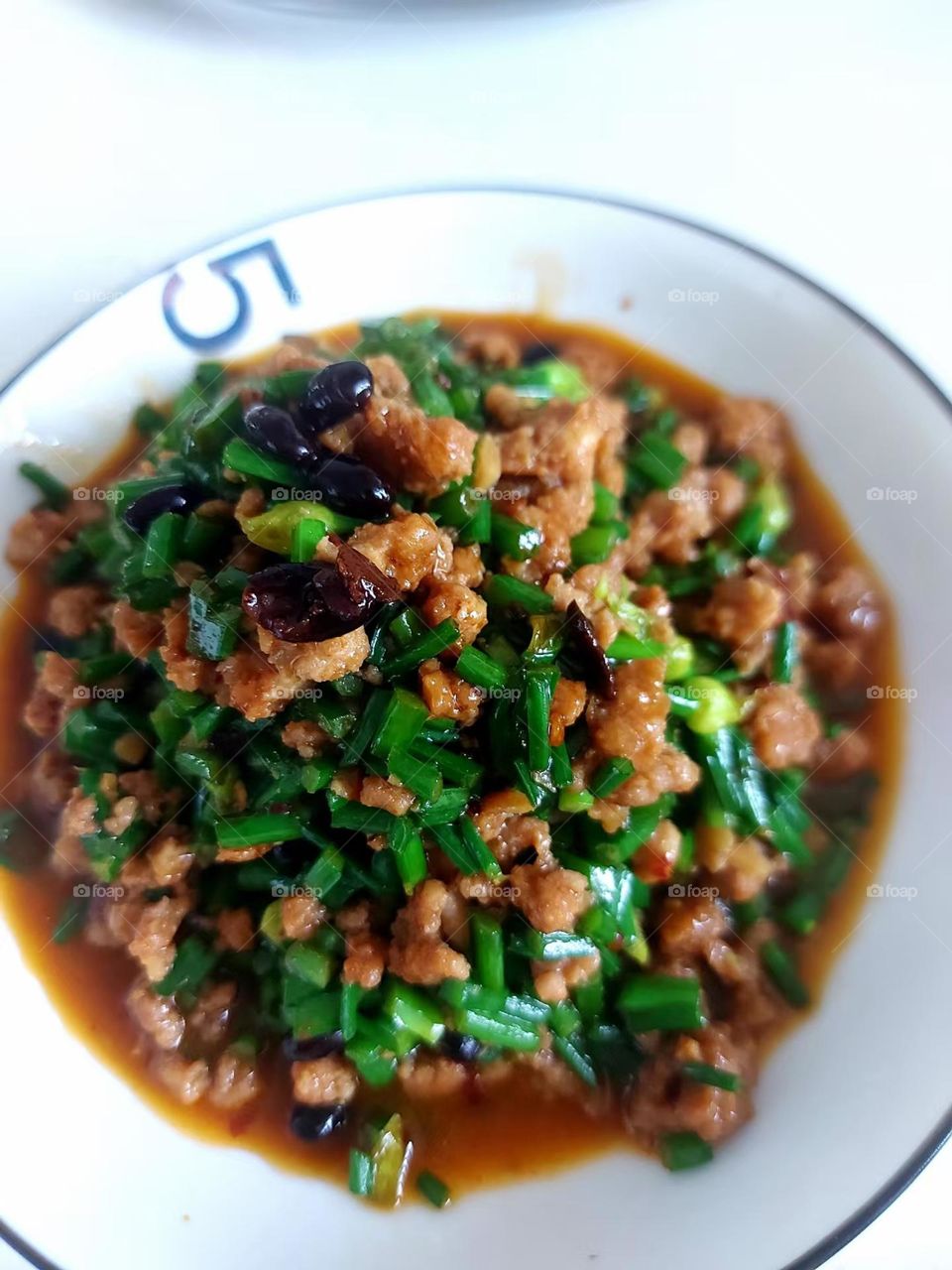 minced pork with chive flowers in black bean sauce