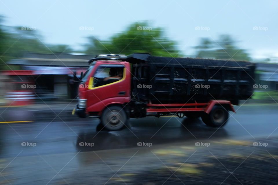 truck driving on asphalt when it rains