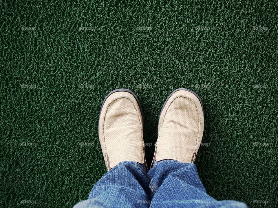 Low section of a man wearing shoes