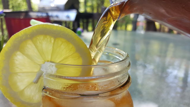 Close-up of pouring ice tea