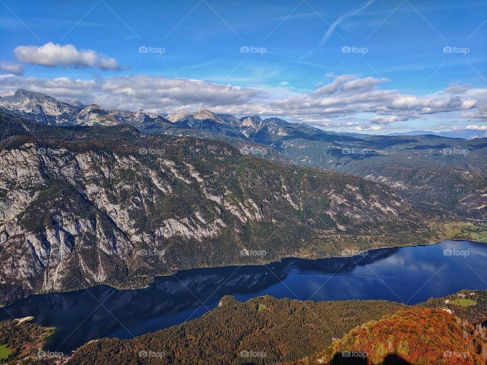 Scenic view of the snow covered Alps mountains reflected in the Slovenian lake Bohinj close up