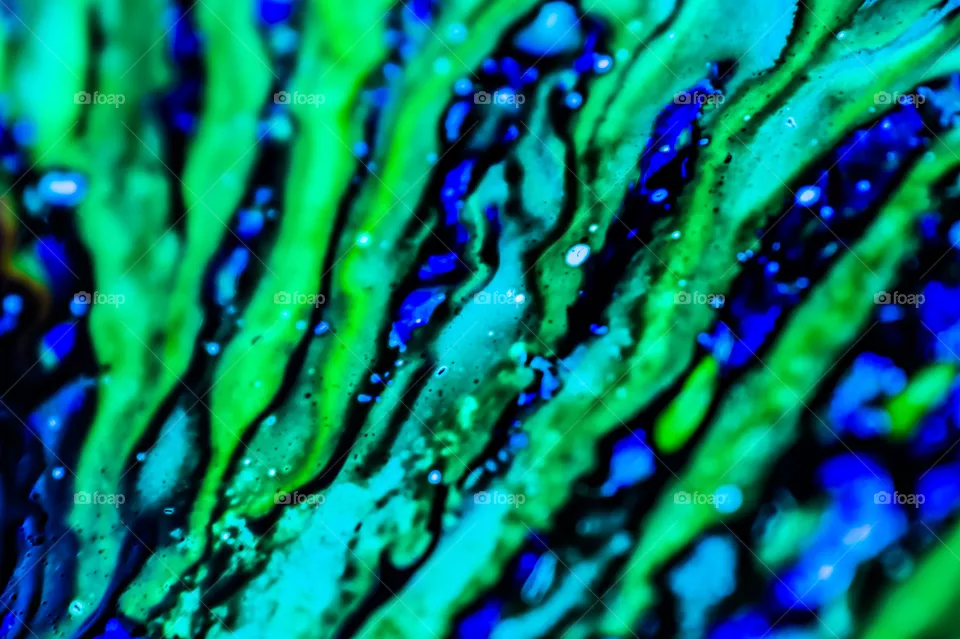 The ink to refill the printer cartridge was spilled onto the white washbasin and the paints blended into abstract drips and patterns.