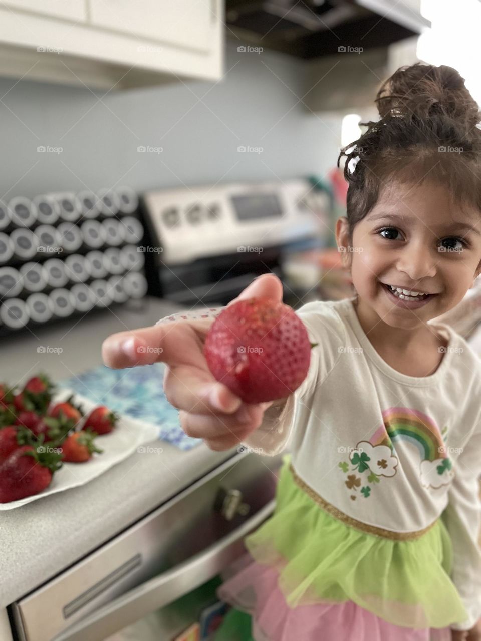 Little girl eating strawberries, preparing strawberries for dessert, delicious strawberries, toddler helps mommy in the kitchen, toddler and mommy time 