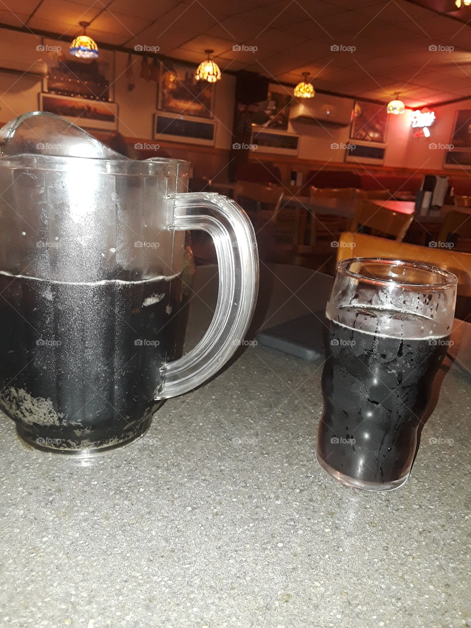 pitcher and glass of cola