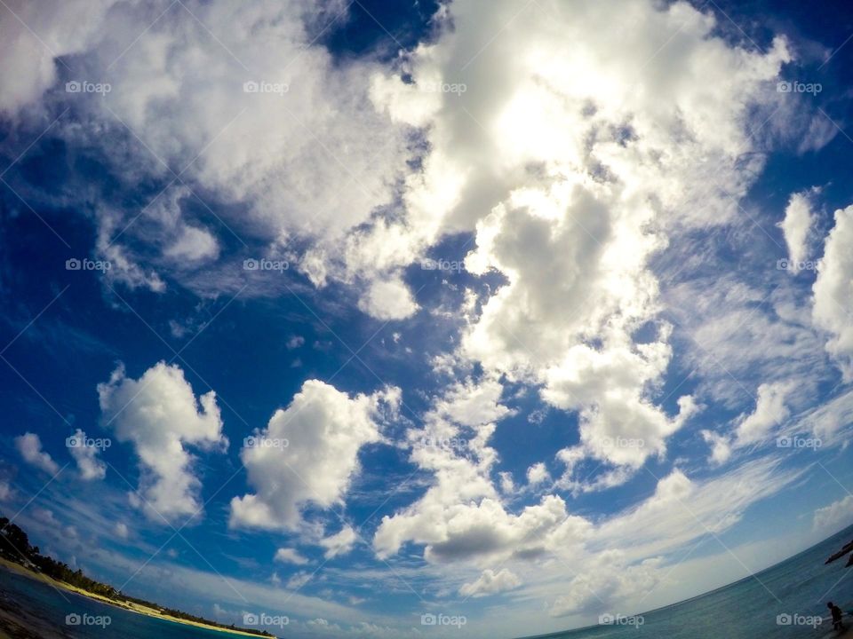 Looking up at the sky, clouds in the sky, Caribbean sky view, beautiful blue skies 