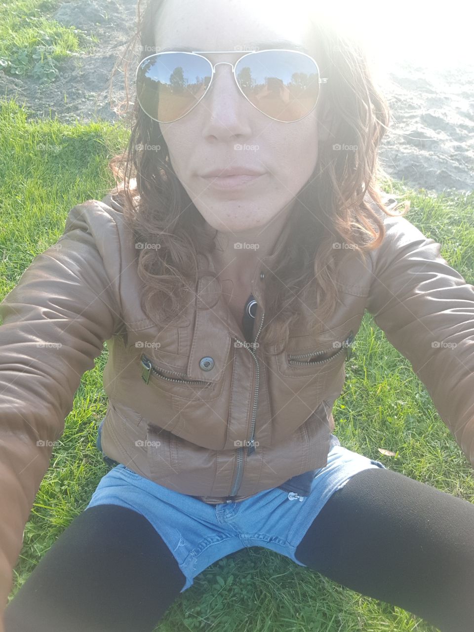 sitting in the grass close to camera