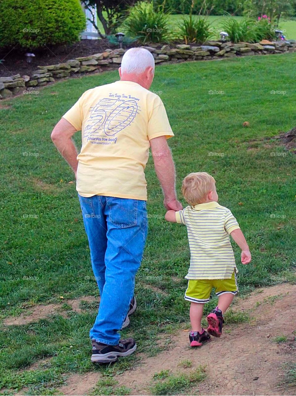 Pappy and Me. Toddler boy walking and holding hands with his Pappy. 