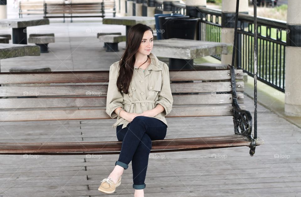 Fashionable woman sitting on bench at outdoors