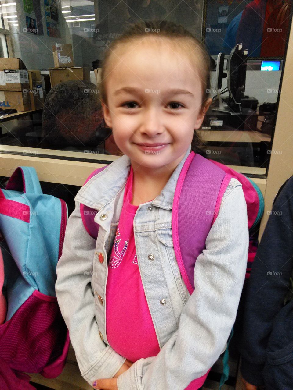 School Days. Little girl wearing backpack standing in line at school