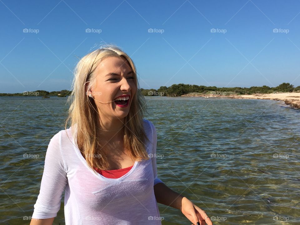 Young happy woman at sea side