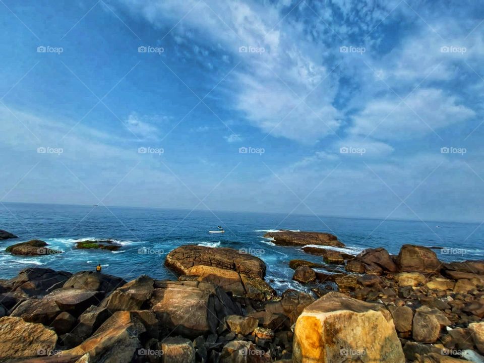Wow, those rocks in the ocean look cool! It must be so calming to see them surrounded by the water.