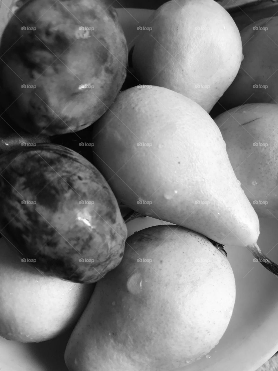 fruits, pears and plums close up,black and white 