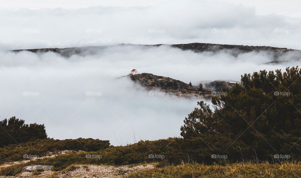 Small house on top of the mountain, surrounded by fog.  Serra da Estrela, Portugal. Star Mountain Range.