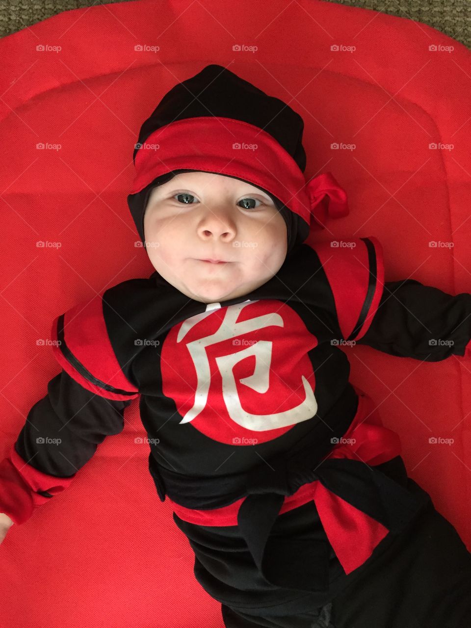 High angle view of baby kid lying on bed