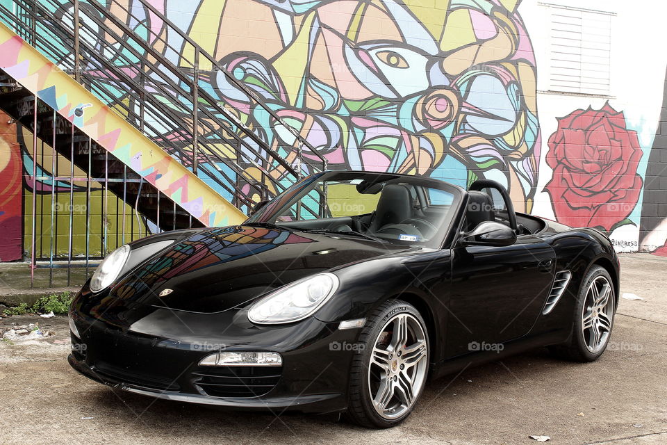 Porsche at graffiti wall gritty