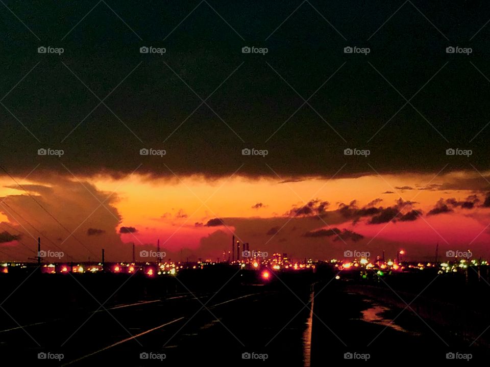 Refinery at Sunset with a storm moving in with thunder clouds near the Sabine River in Texas May 2018 United States of America.