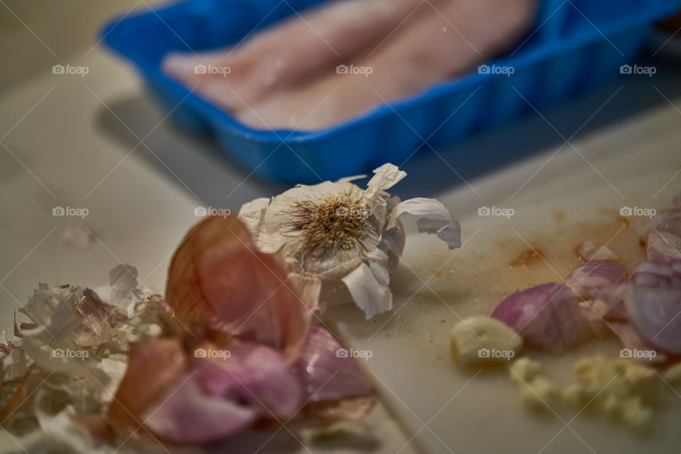   Cooking fish with tomatoes sauce, onion and garlic