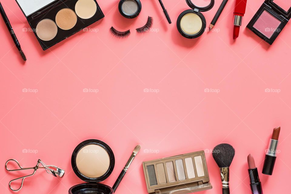 Flat lay of beauty products on pink background 