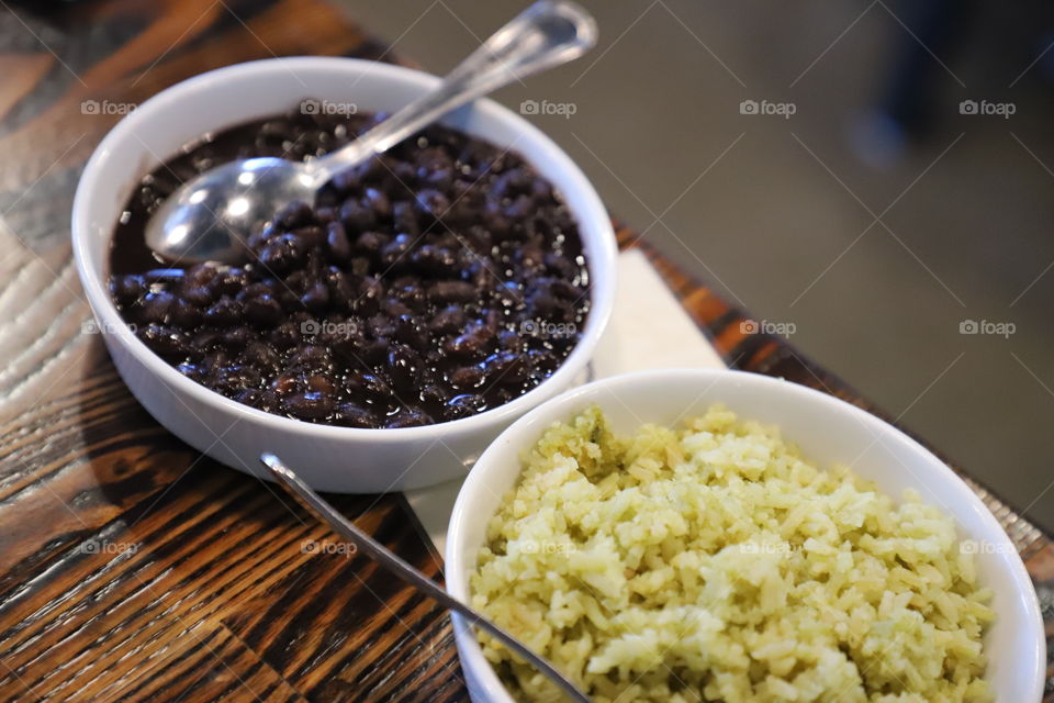 Beans and rice in white bowls