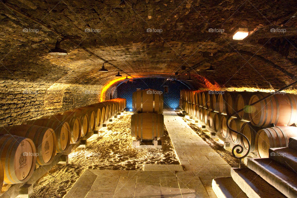 Wine barrels stacked up in the wine cellar at a winery in France