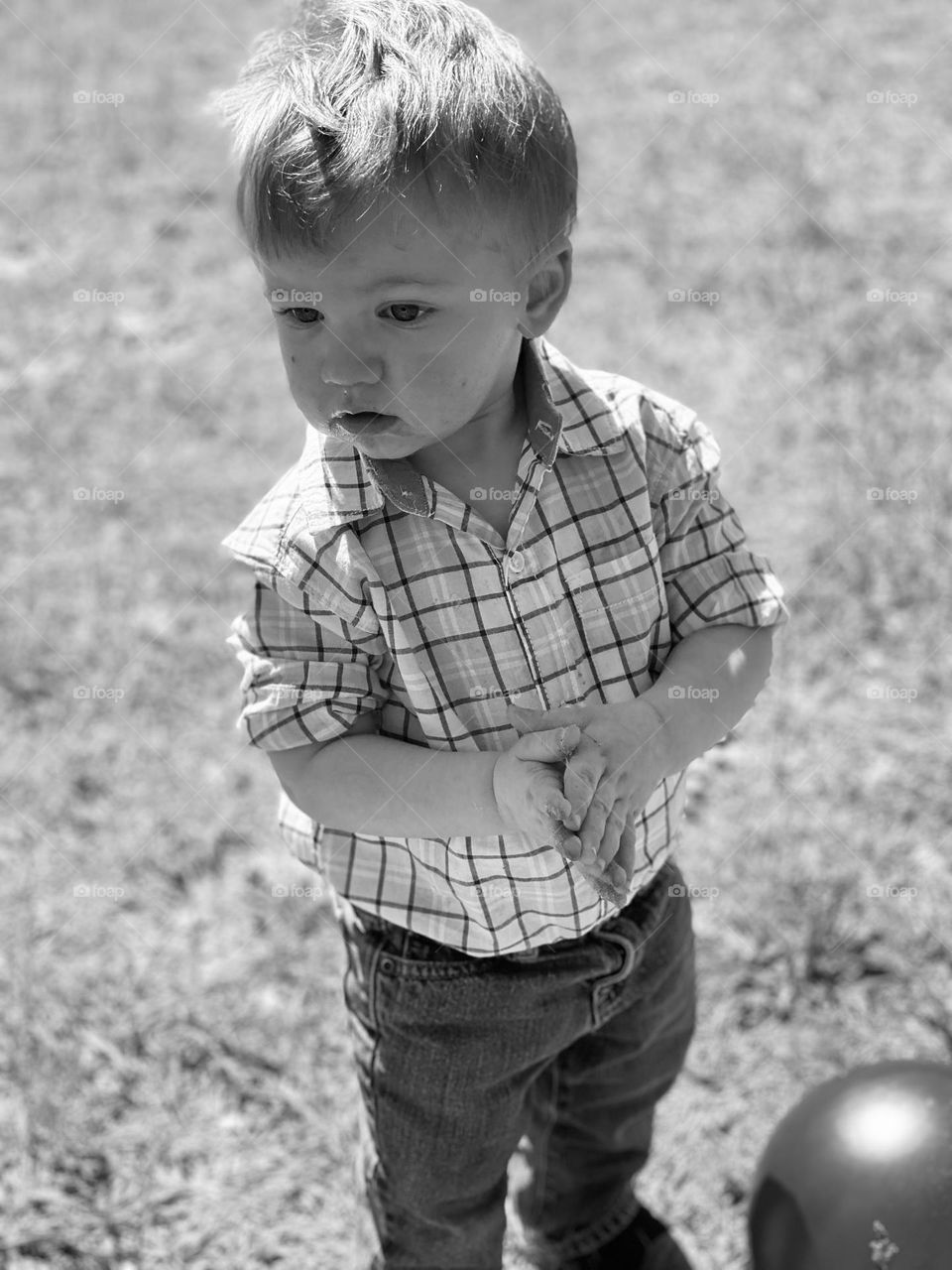 Just a boy taking in all that is around him in his environment, enjoying the great outdoors. 