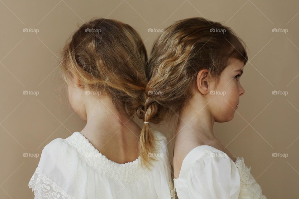 Portrait of cute little girls on a beige background 