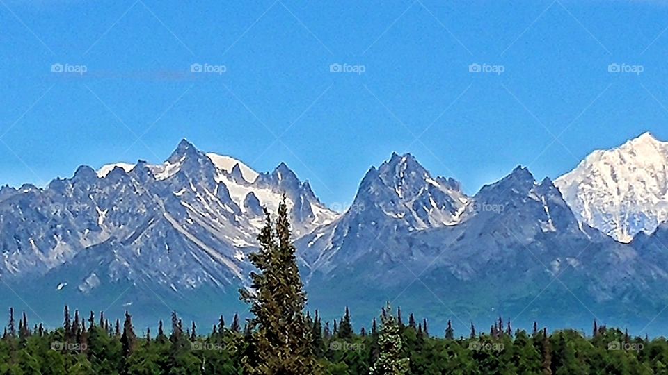 Captivating Moose's Tooth in the magnificent Alaskan Range. Seen on a crystal clear, blue sky day