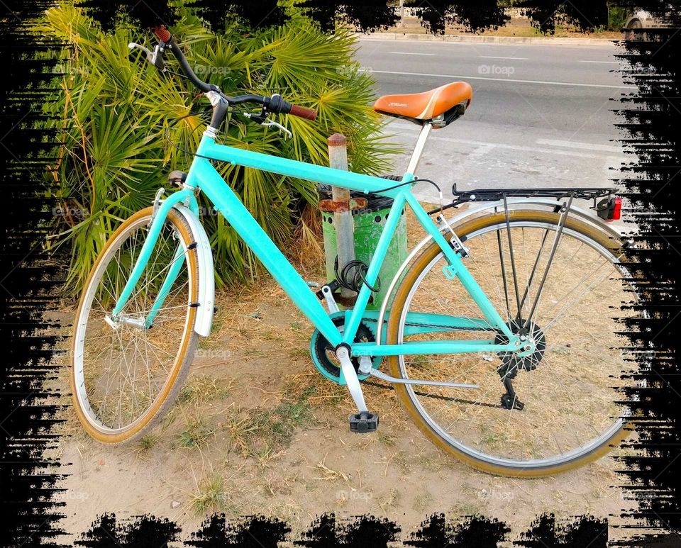 Blue bicycle, parked along the coast of Versilia