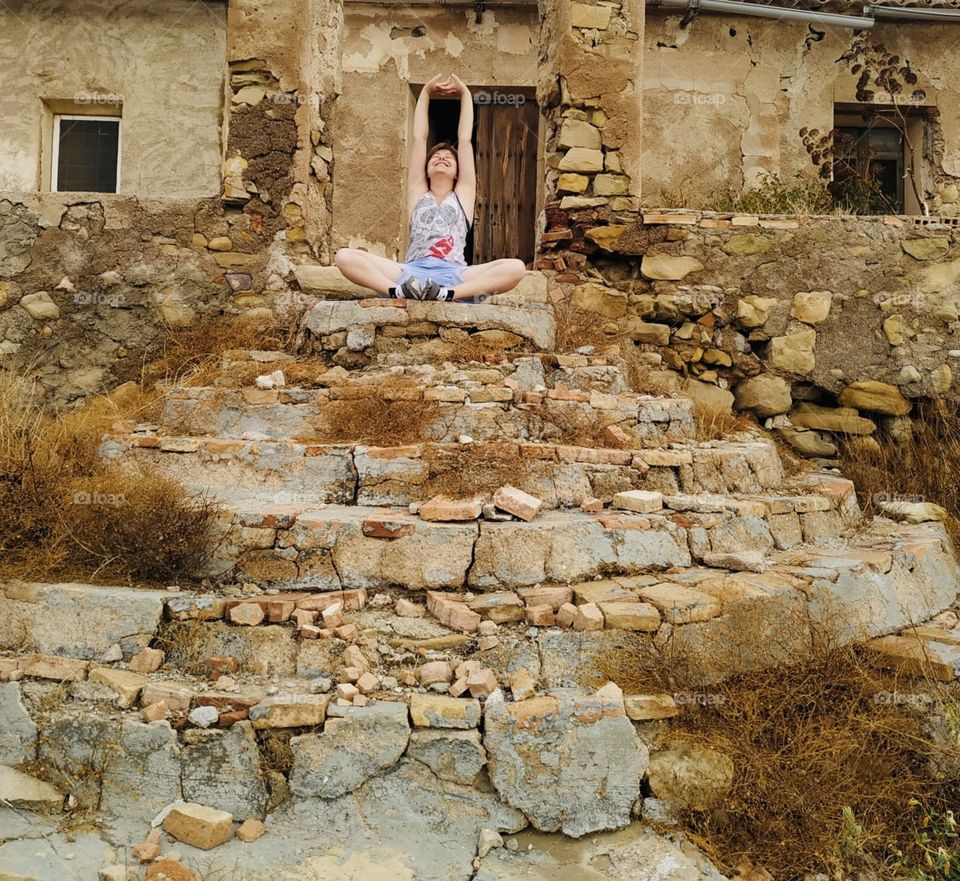 Doing yoga in an abandoned house in the middle of the field. Surrounded by mountains and nature. Always think positive.