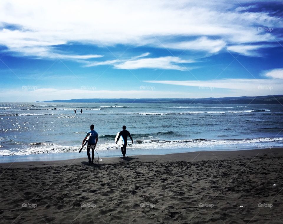 2 Chilean Surfers head into Pichilemu's waters