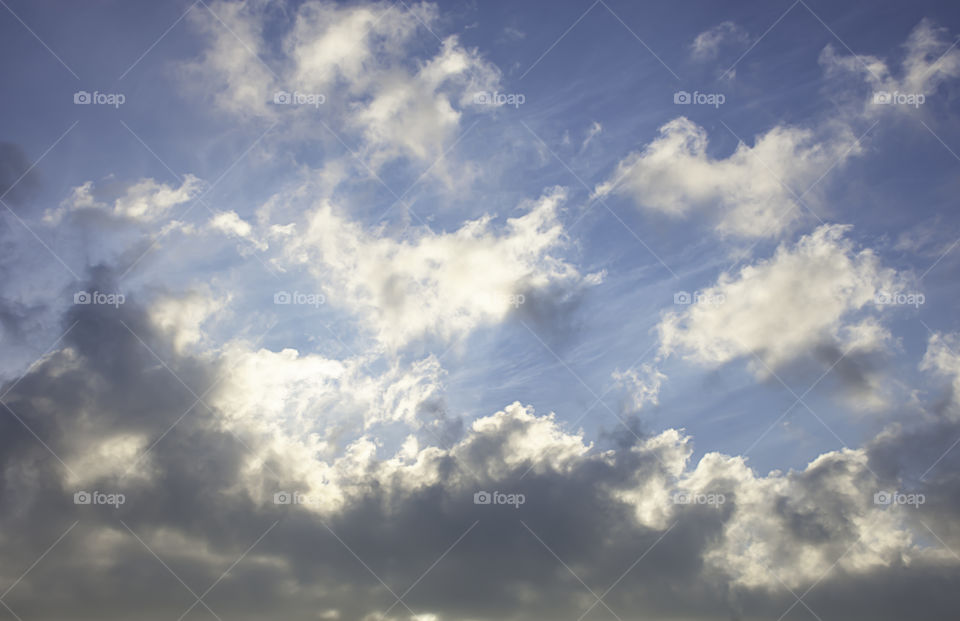 The beauty of the sky with clouds and the sun.