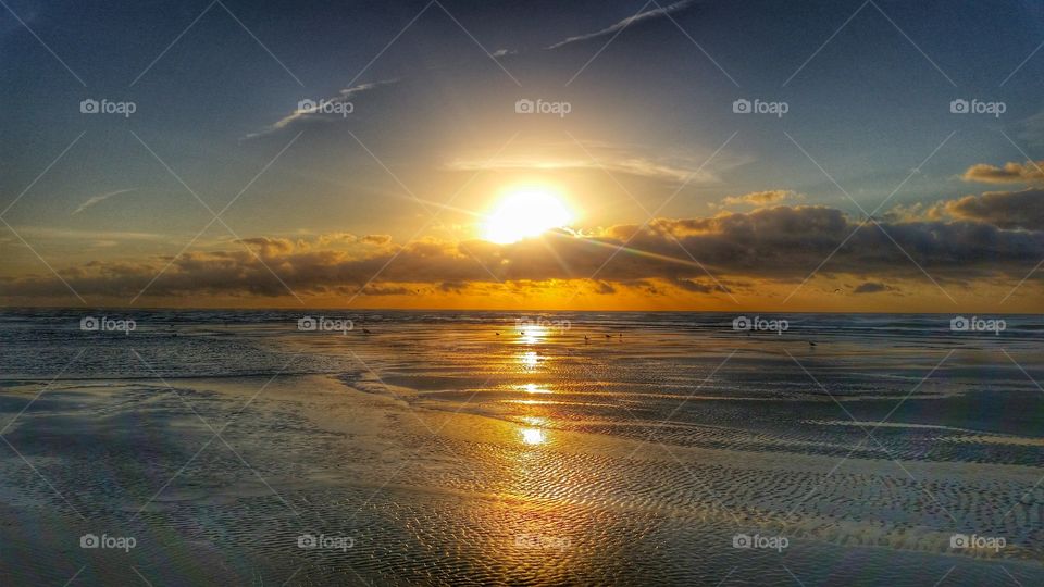 Dramatic sky reflected in sea