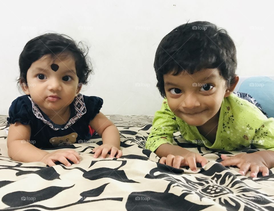 Indian baby boy and baby girl playing together 