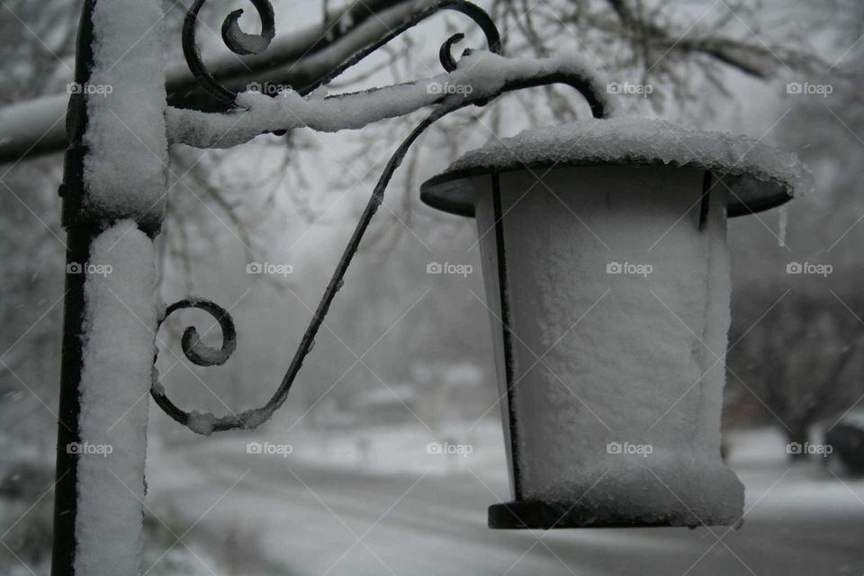 Snow covered lamp post.