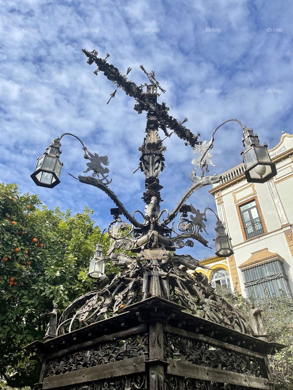 Old monument Santa Cruz Sevilla, iron cross monument, iron piece of art, handmade iron cross, barrio Santa cruz, iconic places in Seville