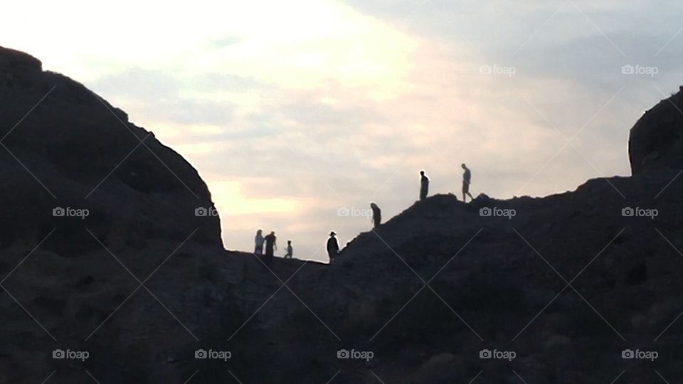People hiking at sunset