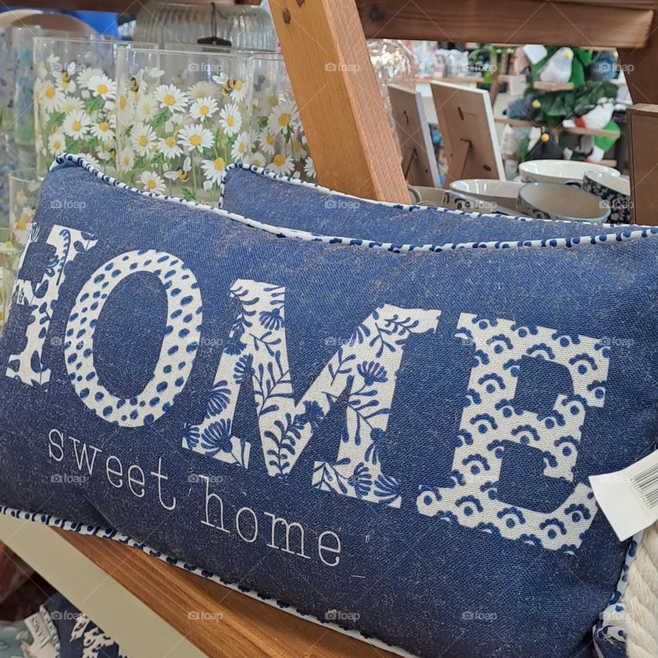 blue no.place like home cushion on shop shelf
