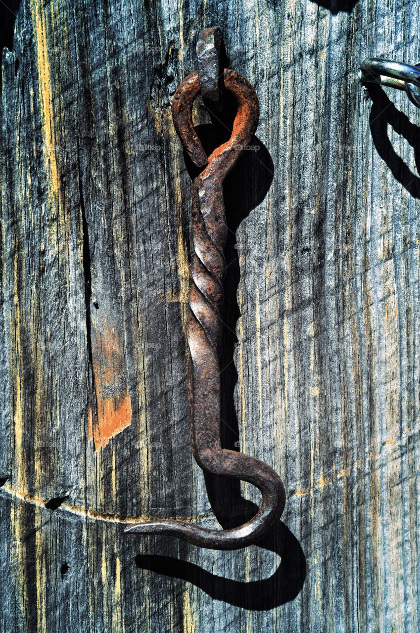 Close-up of metal latch on wooden wall