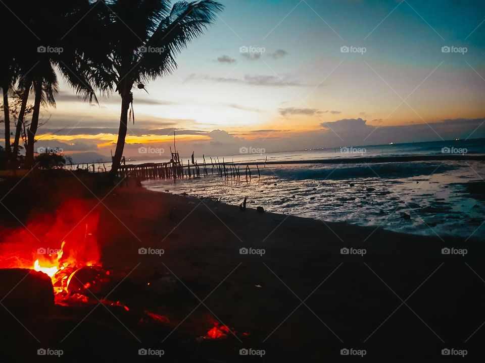 bonfire by the beach at dusk