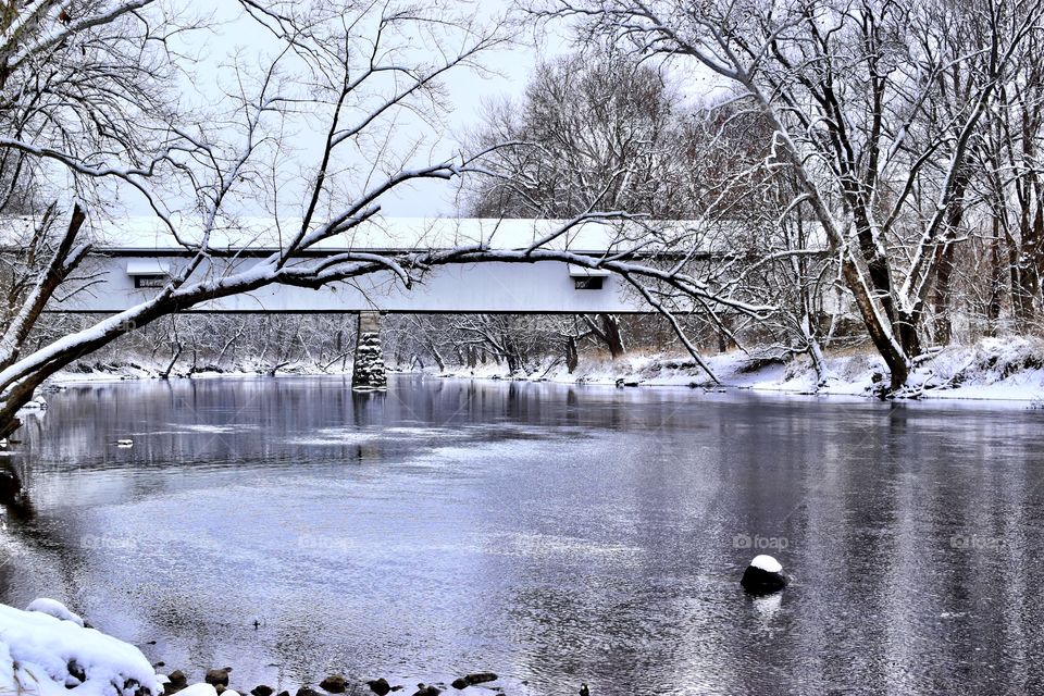 A beautiful winter day at the old covered bridge in Indiana on the white river with beautiful trees