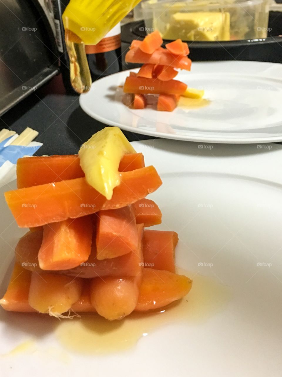 Carrot stick stacks honey and butter food presentation on plate