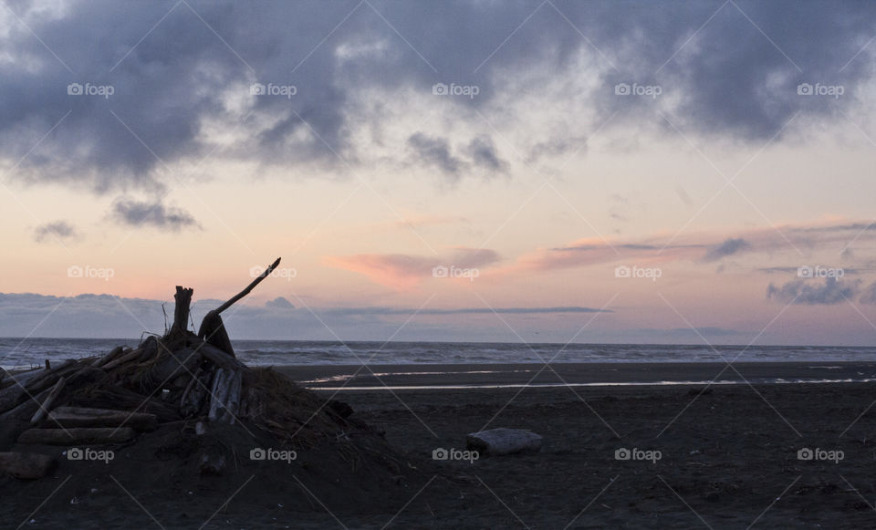 A half buried beach fort on City Beach at sunset in Ocean Shores.
