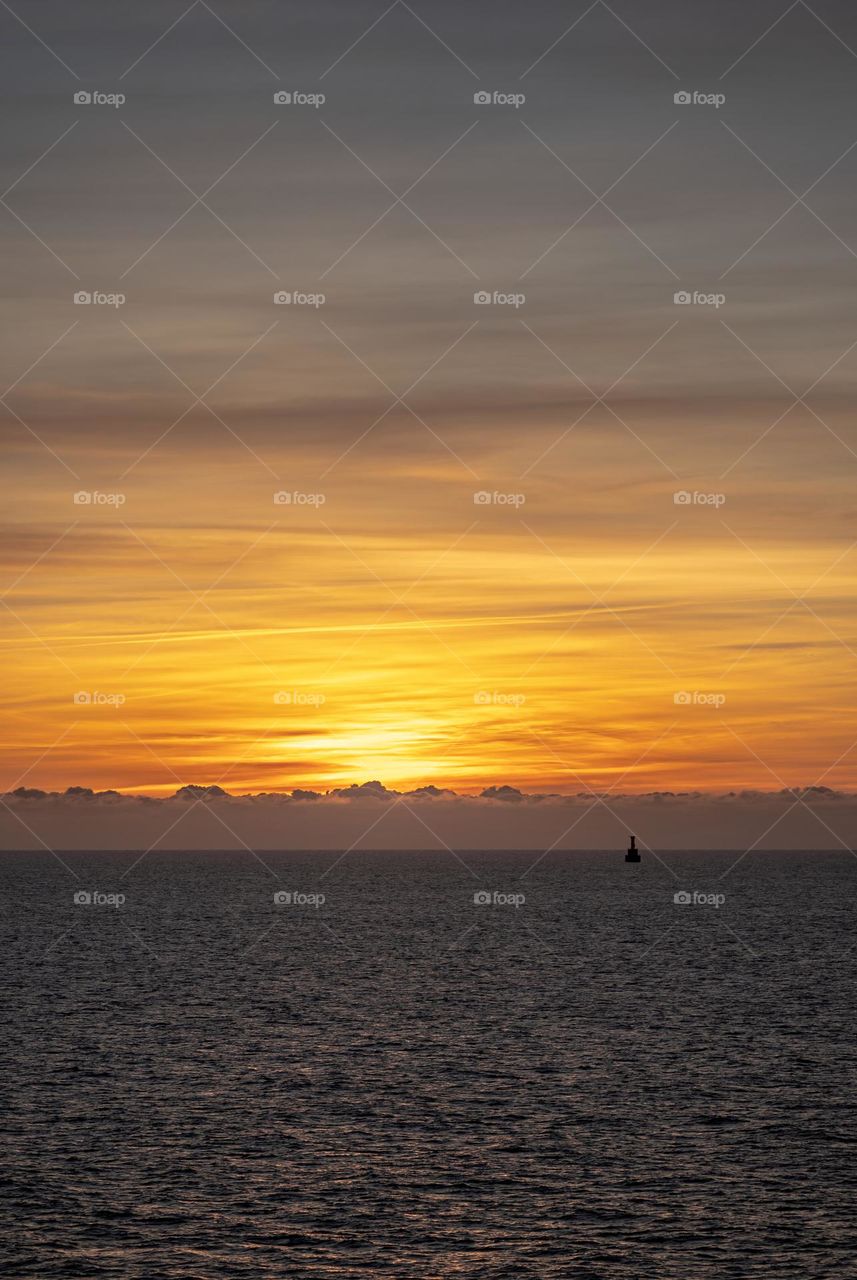 sunrise in the baltic sea and a floating lighthouse