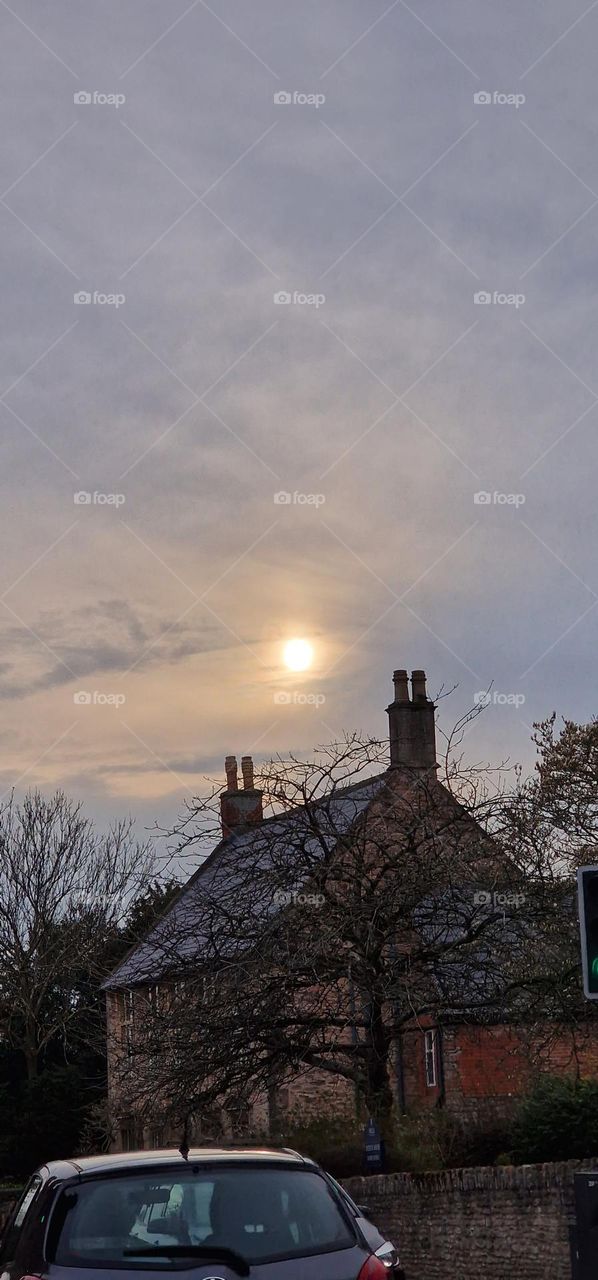 sun over a pretty house