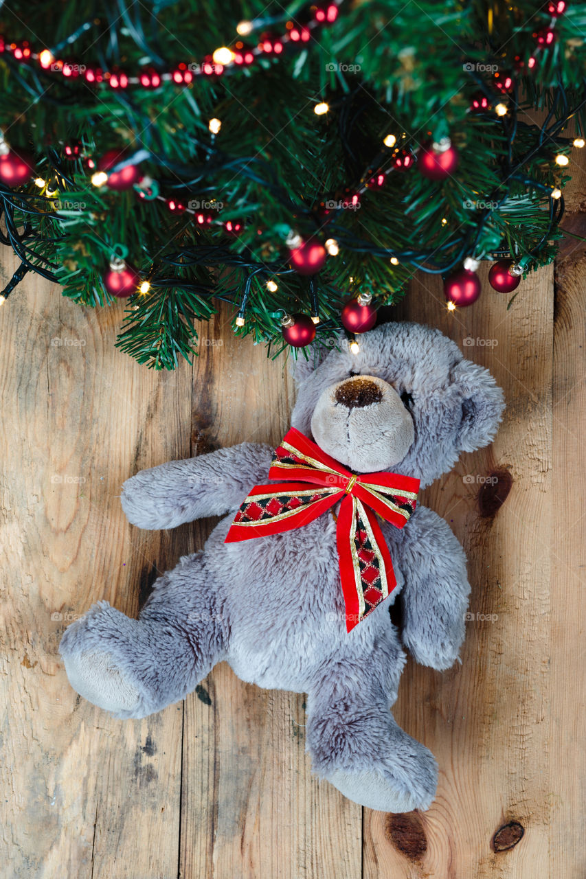 Teddy bear with christmas tree on wooden table