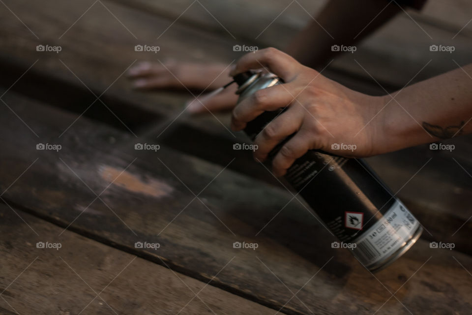 Spraying a wooden board