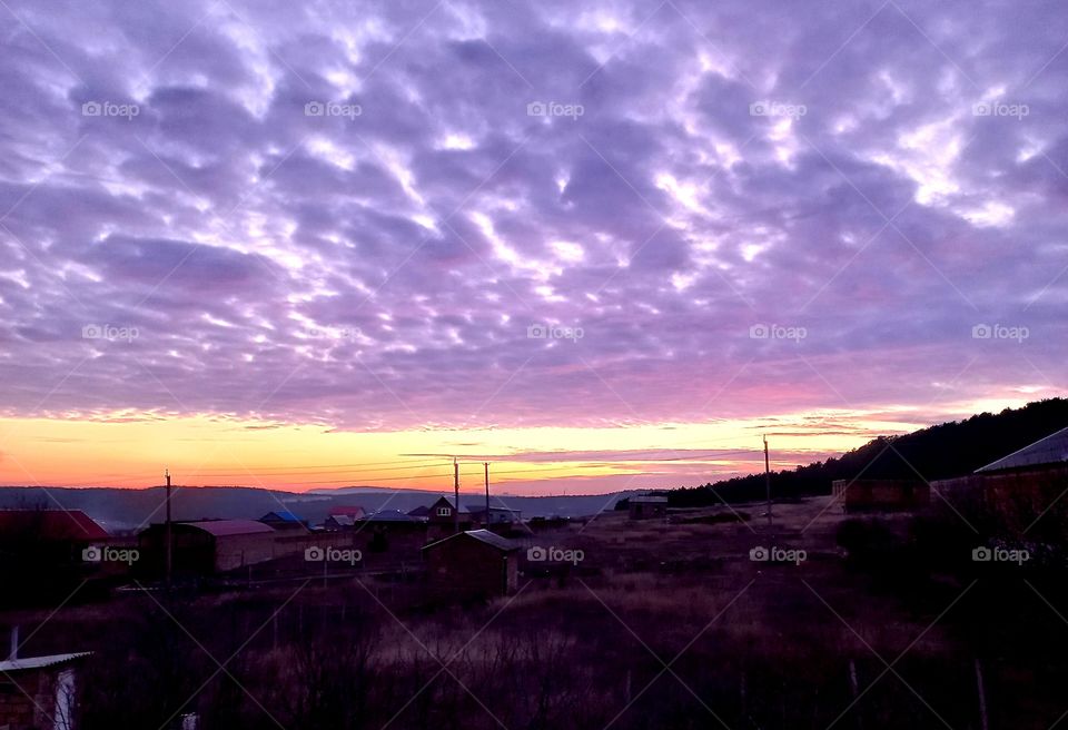 at sunset the sky was covered with purple clouds