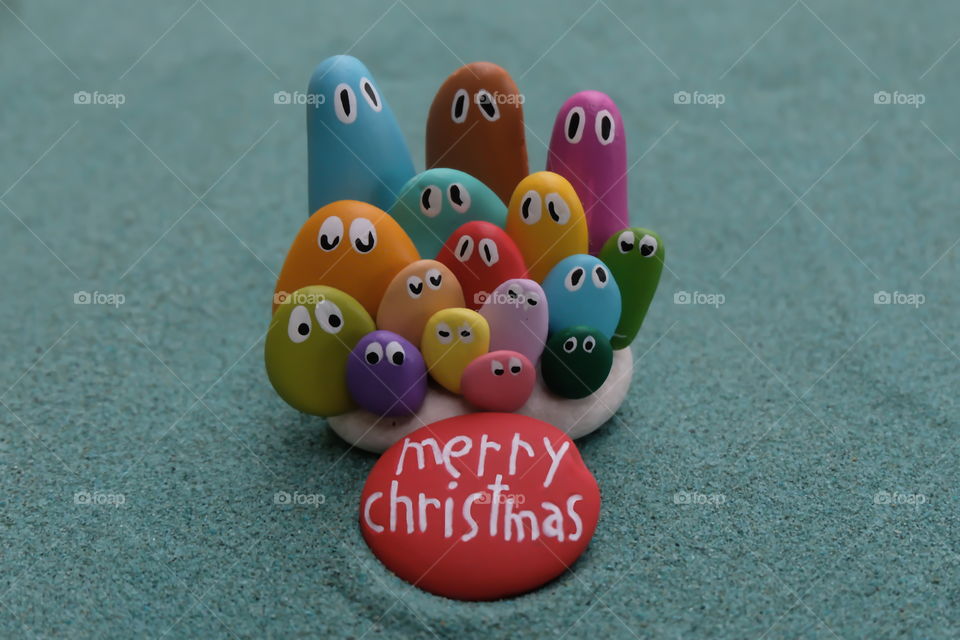 Merry Christmas with multicolored pebble miniatures